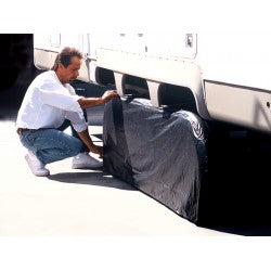 Person Installing Black ADCO Double Axle Tyre Gard on RV Tandem Tires - Installation View | United RV Parts