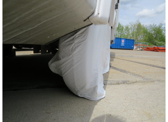 White ADCO RV Tire Cover on Motorhome Wheel - Outdoor Lifestyle Shot | United RV Parts