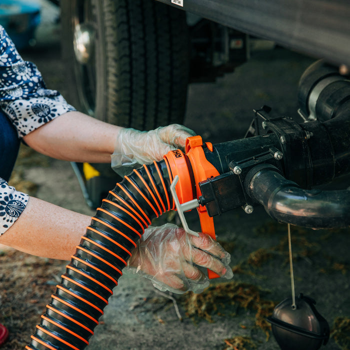 RV Owner Installing Orange RhinoEXTREME Sewer Hose with Gloves | United RV Parts