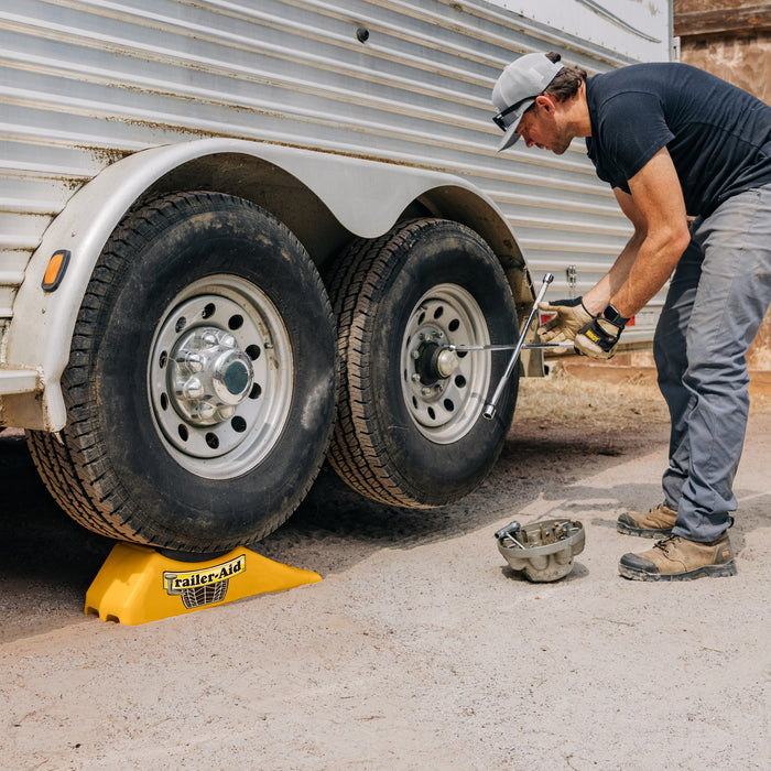 RV Owner Using Trailer-Aid Plus for Tire Maintenance - Action Shot | United RV Parts