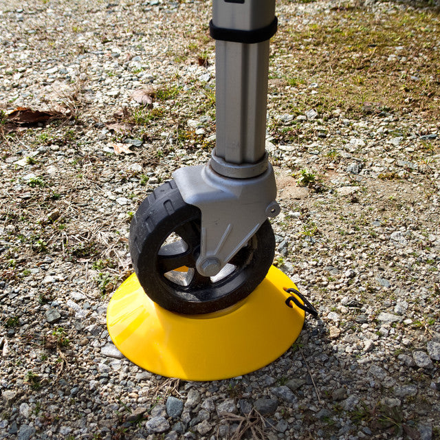 Camco Yellow Wheel Dock Supporting RV Trailer Tongue Jack Wheel on Gravel - In-Use Detail | United RV Parts