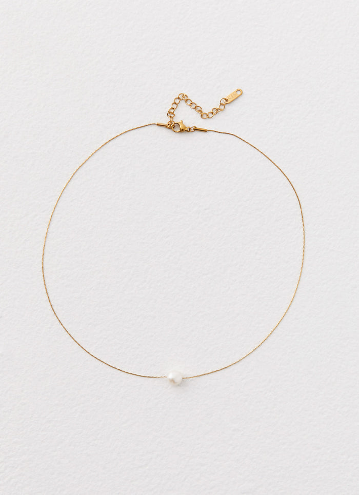 Womens Heartstrings Pearl Necklace in the colour Ivory in front of a light grey background