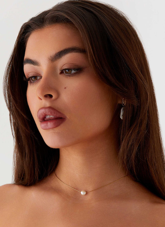 Womens Heartstrings Pearl Necklace in the colour Ivory in front of a light grey background