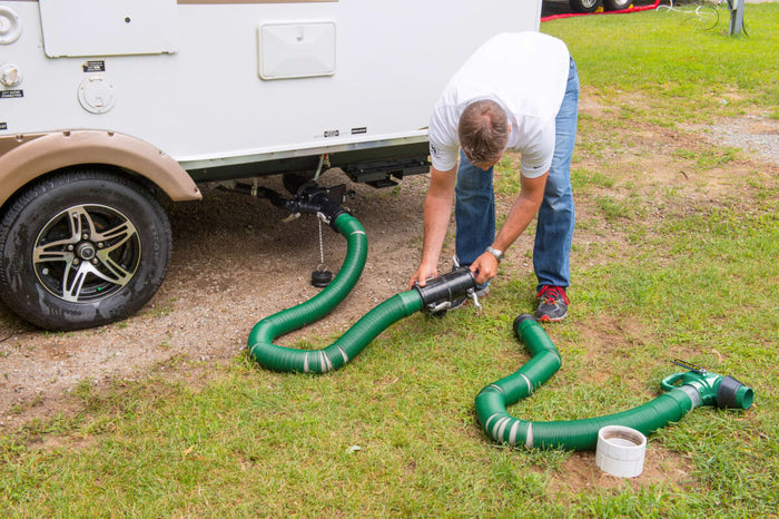 RV Owner Connecting Lippert Waste Master Sewer Hose Extension to Travel Trailer Dump Station - In Use | United RV Parts