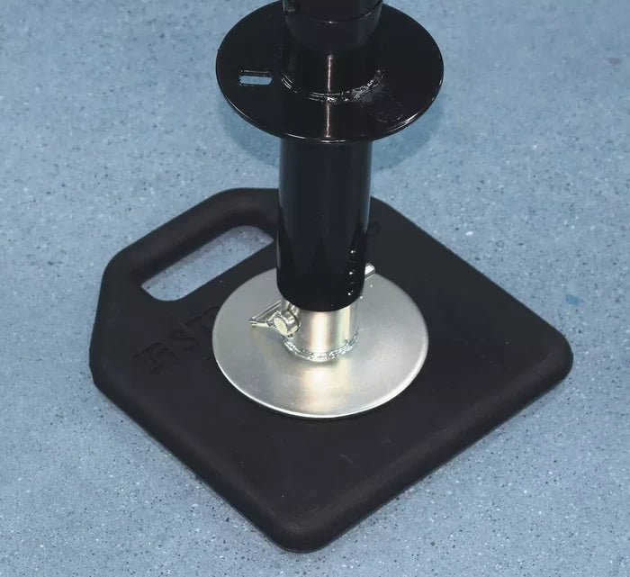 Black EPDM RV Landing Gear Base Pad Under Tongue Jack on Concrete - Close-Up Detail | United RV Parts